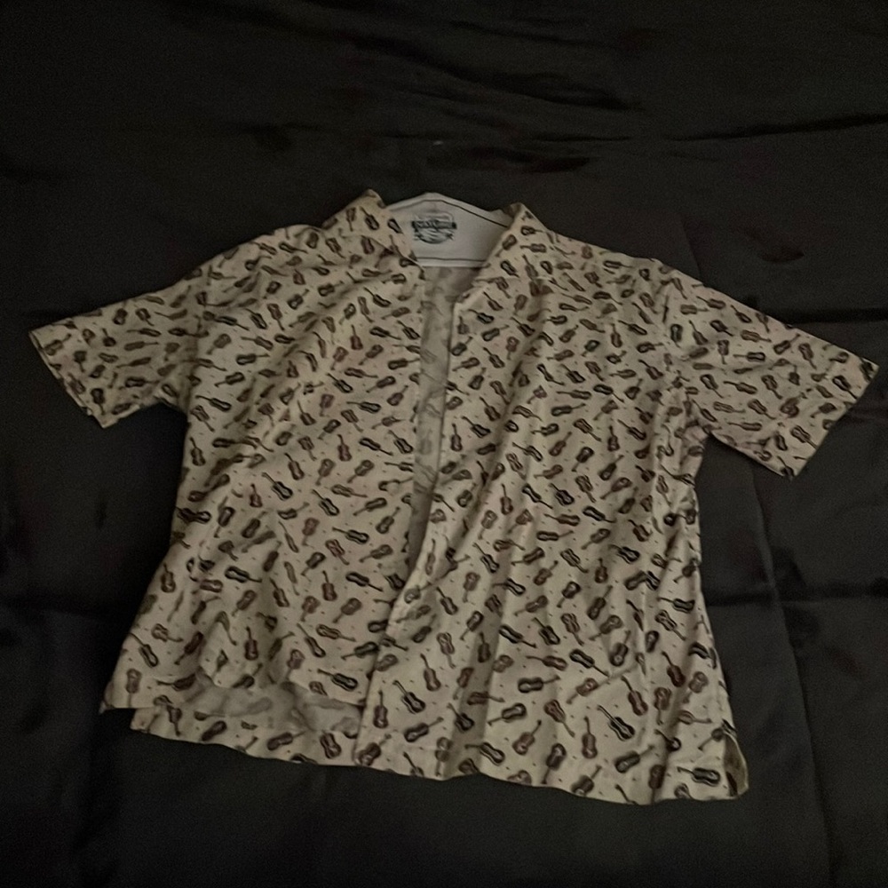 XL shirt from Prints Charming with black and brown acoustic guitars printed.